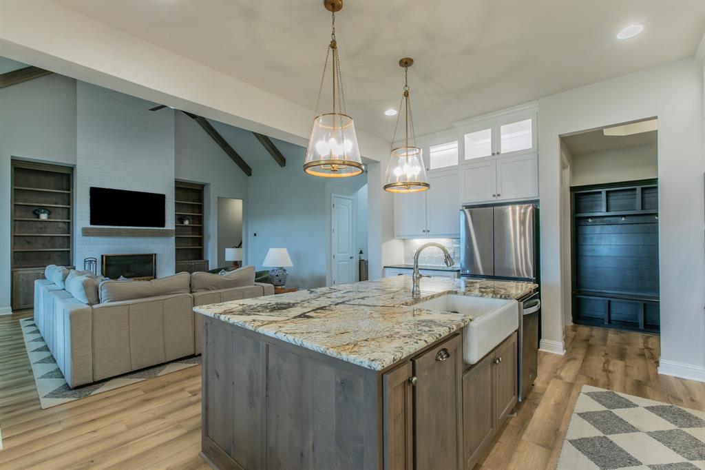 16833 Chapel Road Lorena, TX 76655 - Photo 8 of 40 a open kitchen with stainless steel appliances kitchen island granite countertop a sink and a fireplace