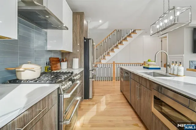 a kitchen with a sink stove and cabinets