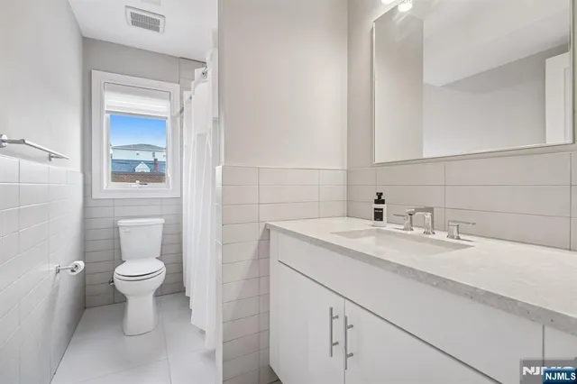 a bathroom with a sink toilet and a mirror