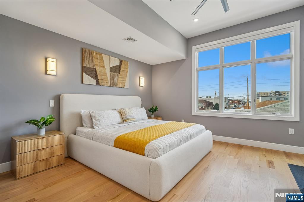 305 8th Street, Unit 2 Fairview, NJ 07022 - Photo 20 of 30 a living room with a bed furniture and next to a window