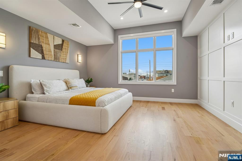305 8th Street, Unit 2 Fairview, NJ 07022 - Photo 23 of 30 a bedroom with a bed and a large window