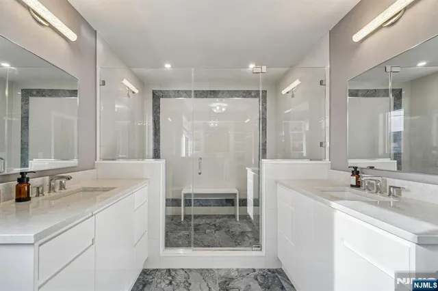 a bathroom with a sink double vanity and a shower