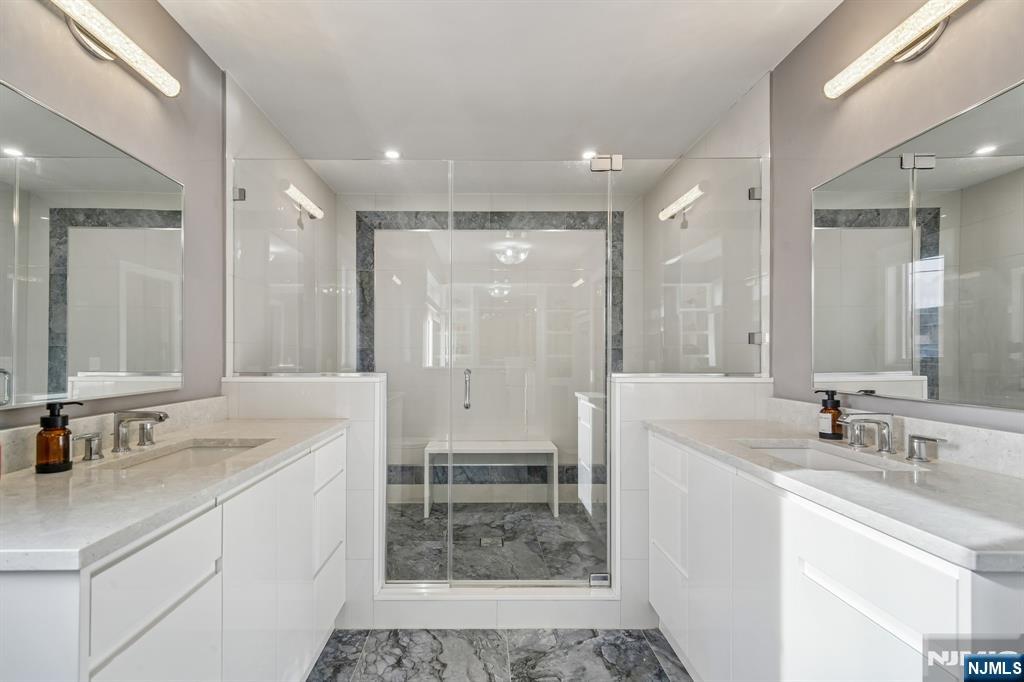 305 8th Street, Unit 2 Fairview, NJ 07022 - Photo 24 of 30 a bathroom with a sink double vanity and a shower