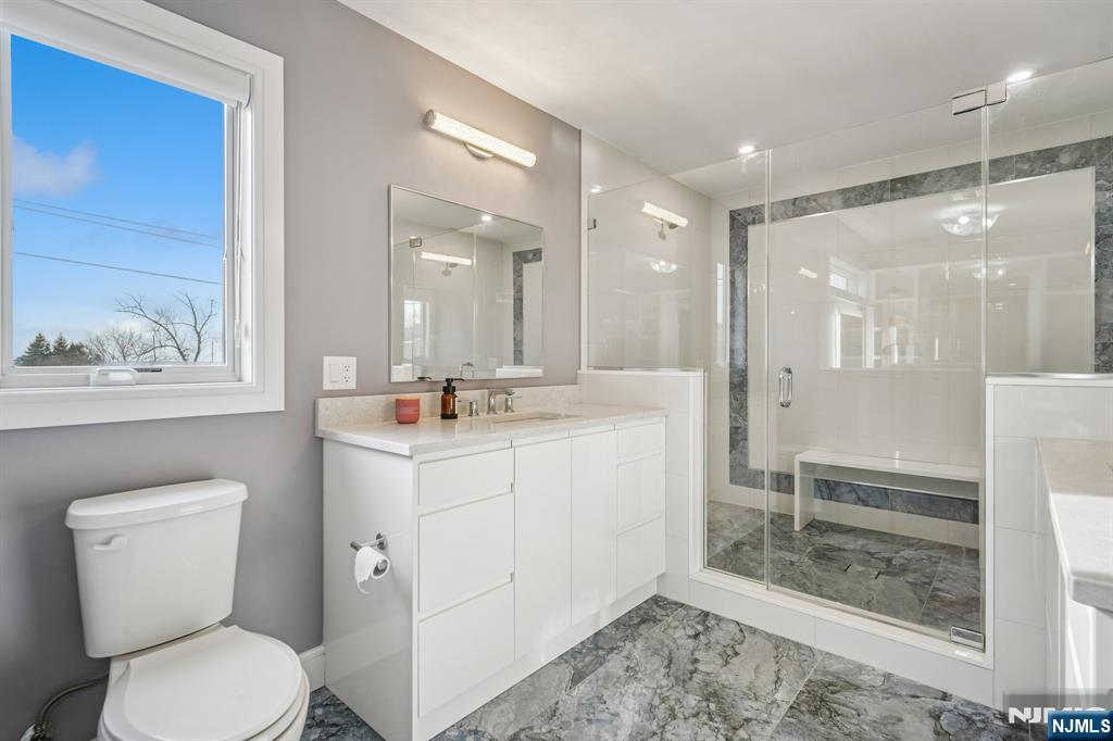 305 8th Street, Unit 2 Fairview, NJ 07022 - Photo 25 of 30 a bathroom with a toilet sink and a mirror