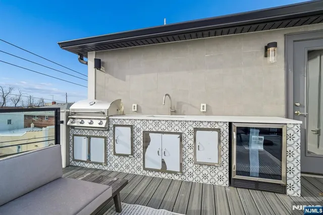 a roof deck with a table and chairs
