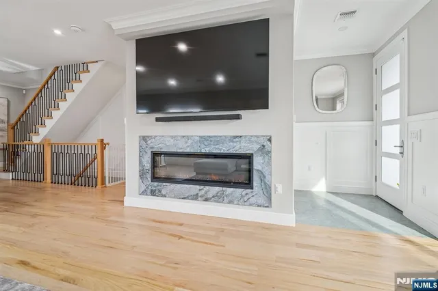 a living room with a fireplace a flat screen tv and a fireplace