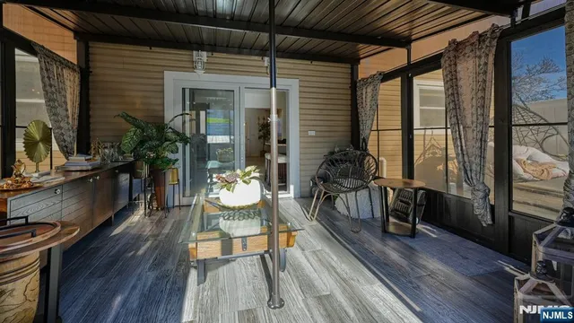 a dining room with wooden floor and furniture