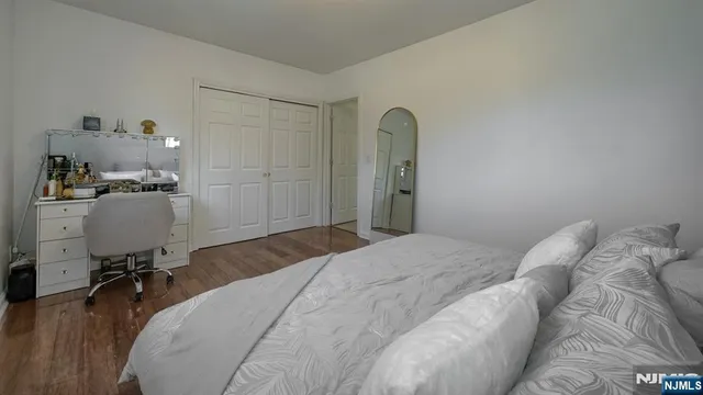 a bedroom with a bed and a desk