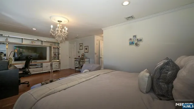 a bedroom with a bed and a chandelier