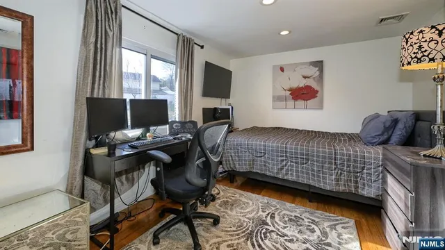 a bedroom with a bed and a desk
