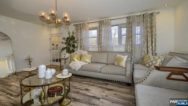a living room with furniture and a chandelier