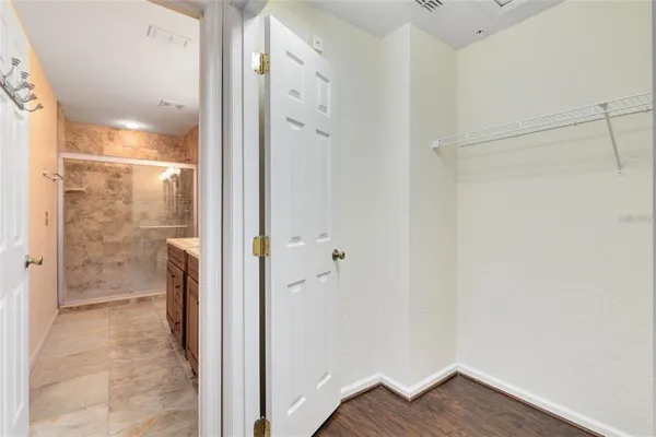 a bathroom with a shower and a glass door