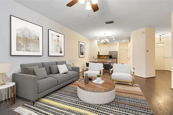a living room with furniture and a chandelier