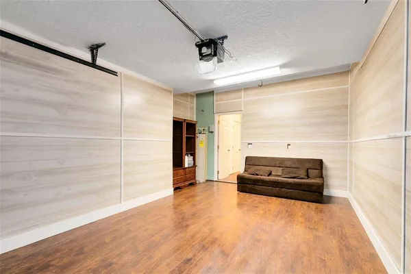 a living room with a bed and a ceiling fan