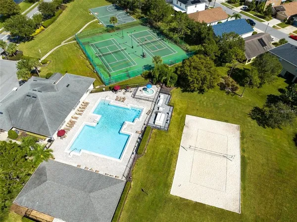 an aerial view of a house with a yard basket ball court and outdoor seating