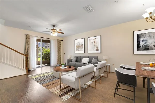a living room with furniture a piano and a window