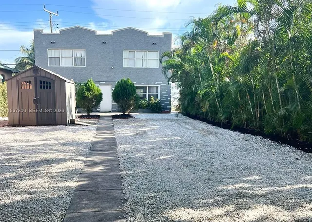 a view of a brick house with a yard