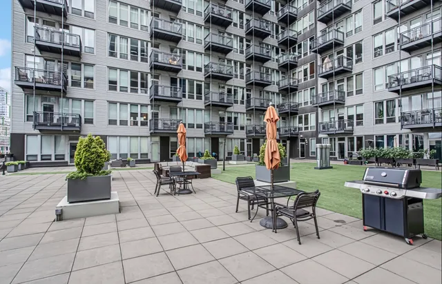 a view of a patio with dining table and chairs