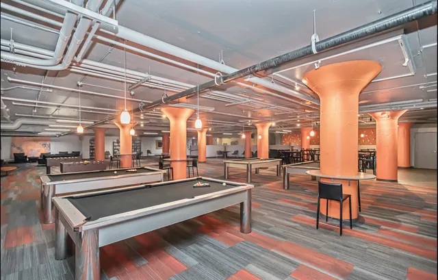 a room with lots of table and chairs