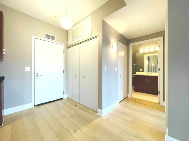 a view of a hallway with wooden shelves
