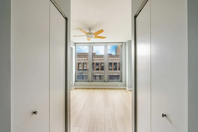 a view of a room with wooden floor and windows