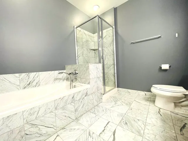 a bathroom with a bathtub and shower
