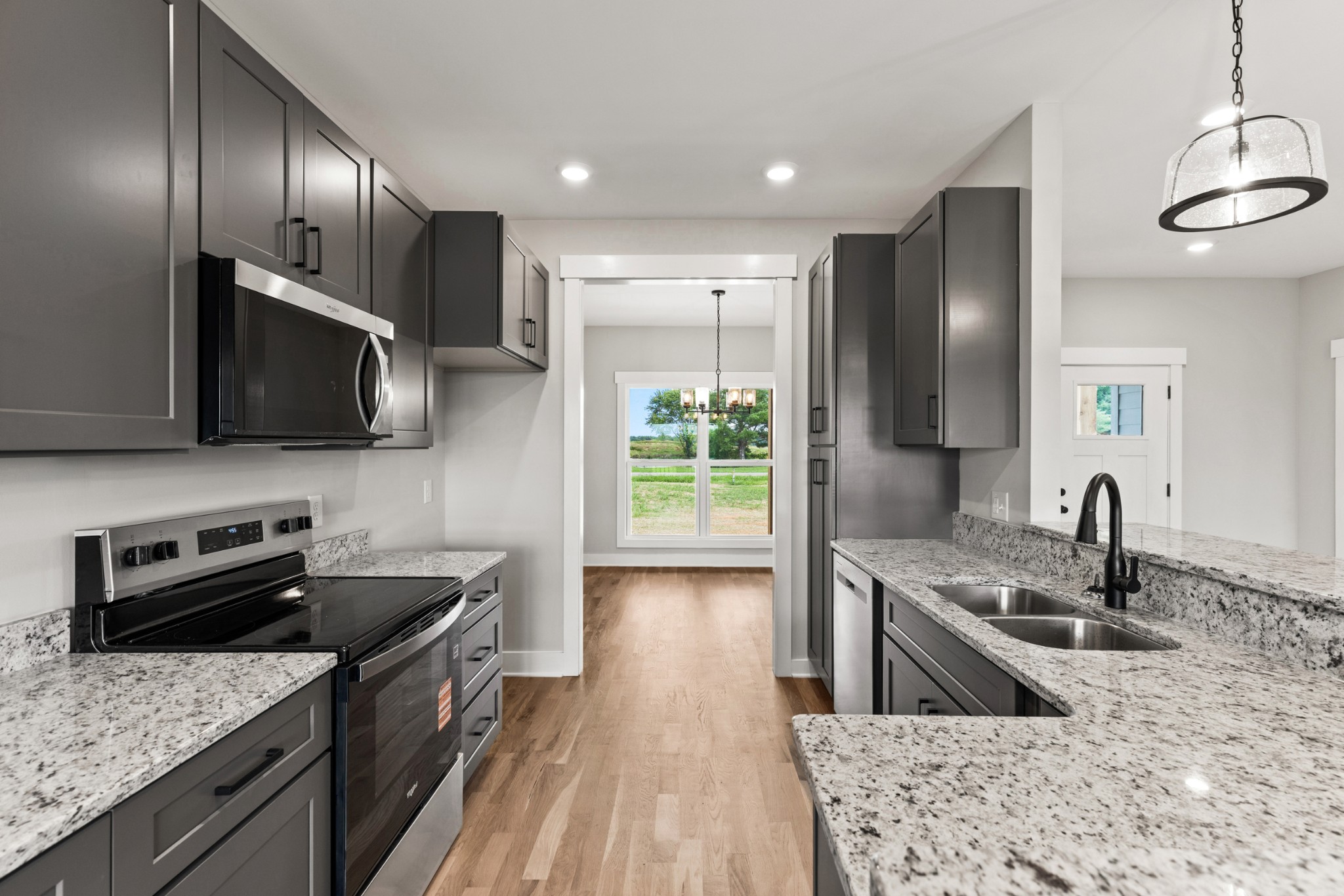 5638 Borthick Road Springfield, TN 37172 - Photo 3 of 43 a kitchen with stainless steel appliances granite countertop a sink stove and refrigerator