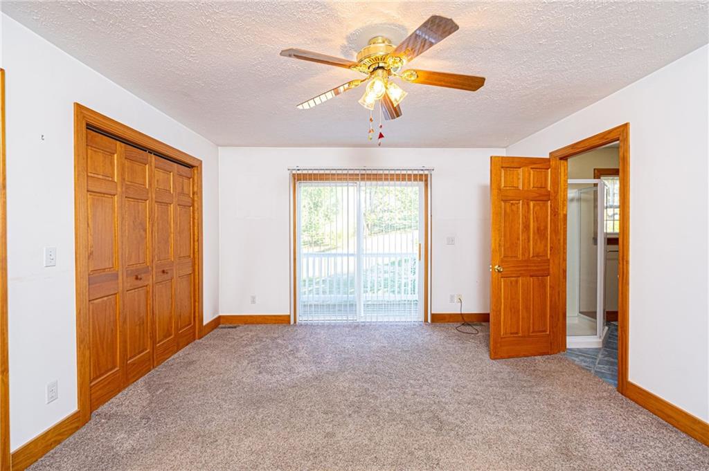 1531 Washington Road Apollo, PA 15613 - Photo 12 of 25 Master Bedroom with huge double closet and sliding doors out to the deck and en-suite bathroom.