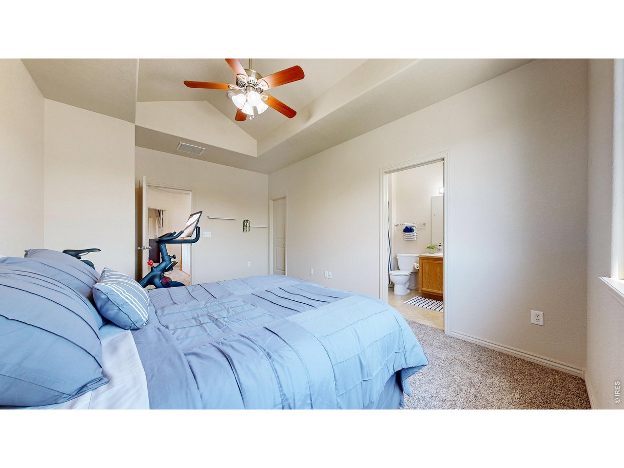 4672 West 20th Road, Unit 413 Greeley, CO 80634 - Photo 26 of 37 a bedroom with a bed and a large mirror