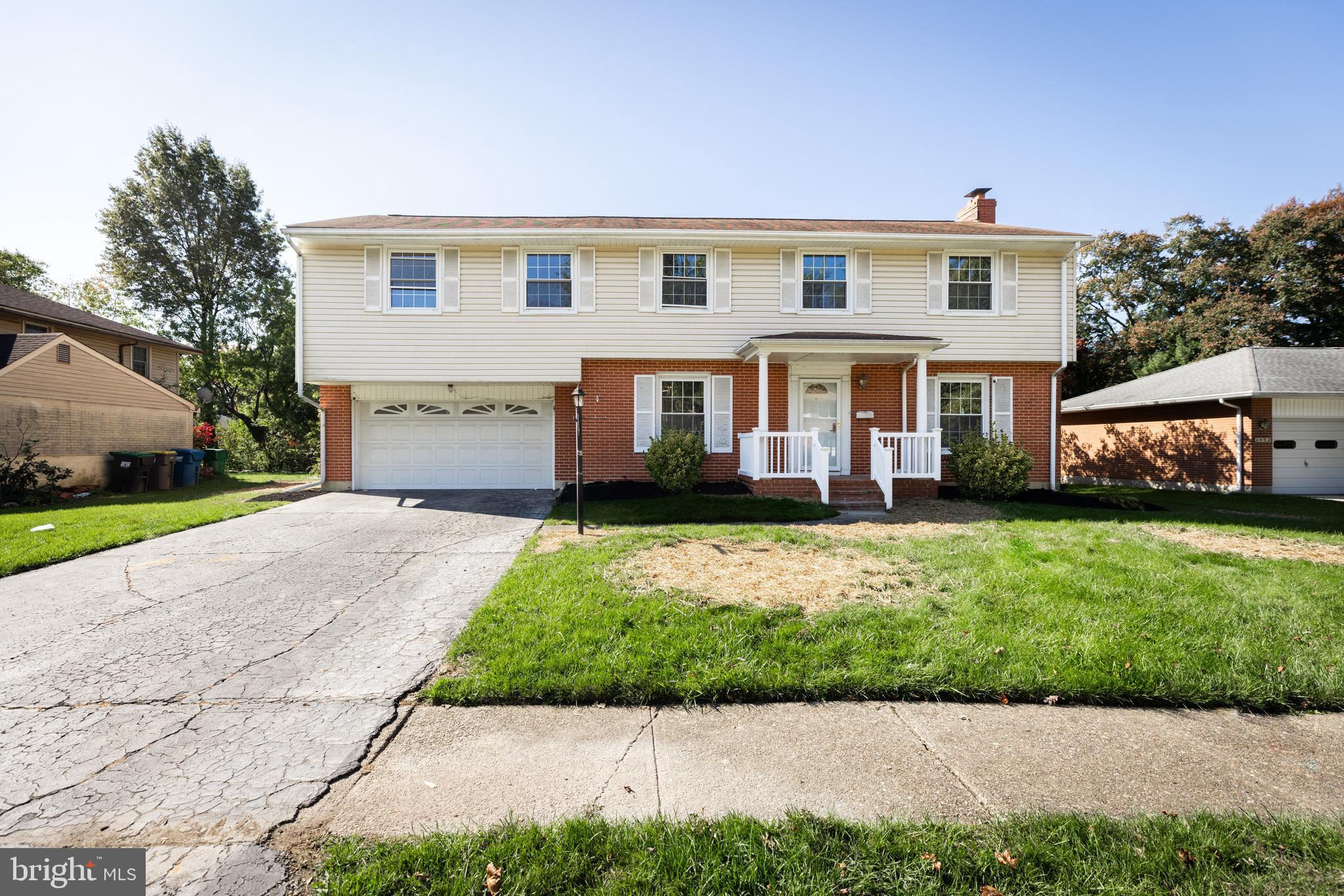 a front view of a house with a garden and plants