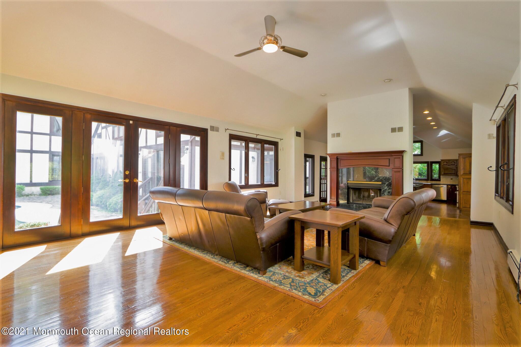 7 Perrine Circle Millstone Township, NJ 08535 - Photo 19 of 27 a living room with fireplace furniture and a large window