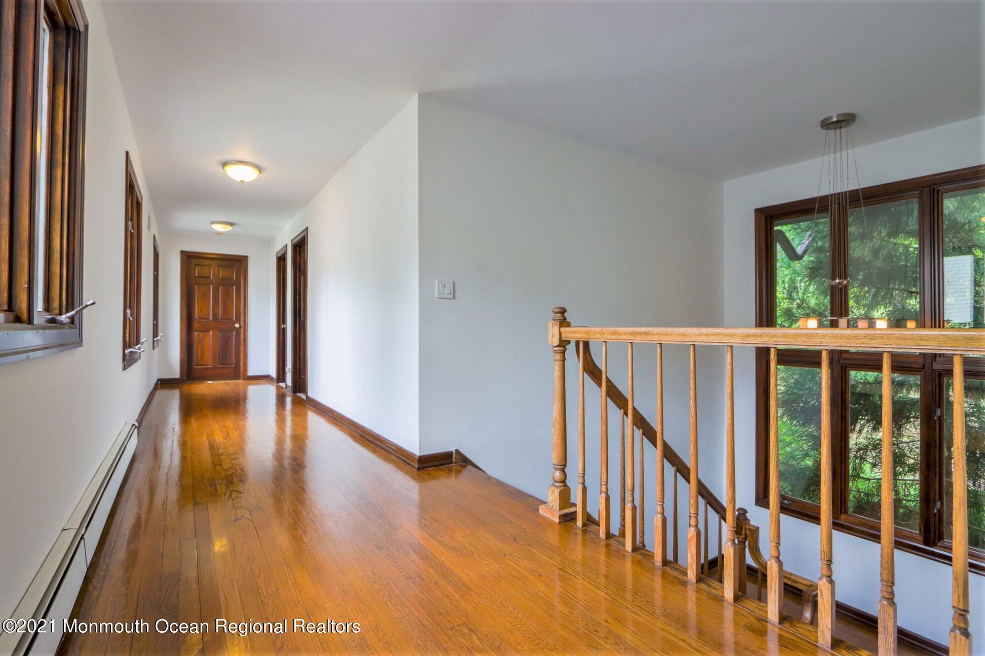 7 Perrine Circle Millstone Township, NJ 08535 - Photo 24 of 27 a view of a hallway with wooden floor and stairs