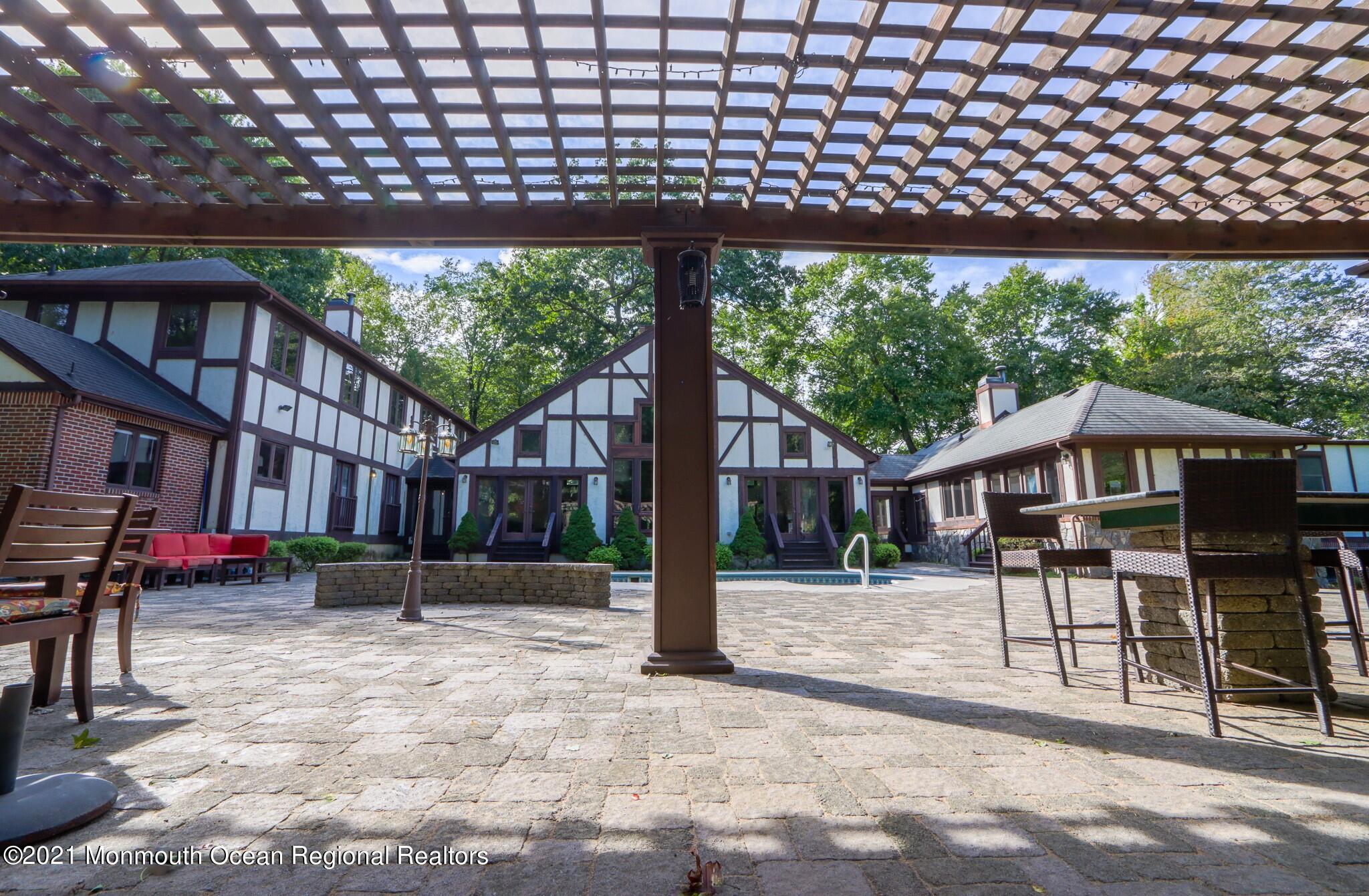 7 Perrine Circle Millstone Township, NJ 08535 - Photo 25 of 27 a backyard of a house with barbeque oven table and chairs
