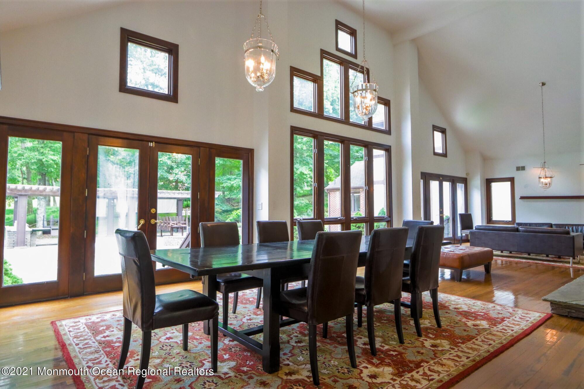 7 Perrine Circle Millstone Township, NJ 08535 - Photo 7 of 27 a view of a dining room with furniture a chandelier and wooden floor