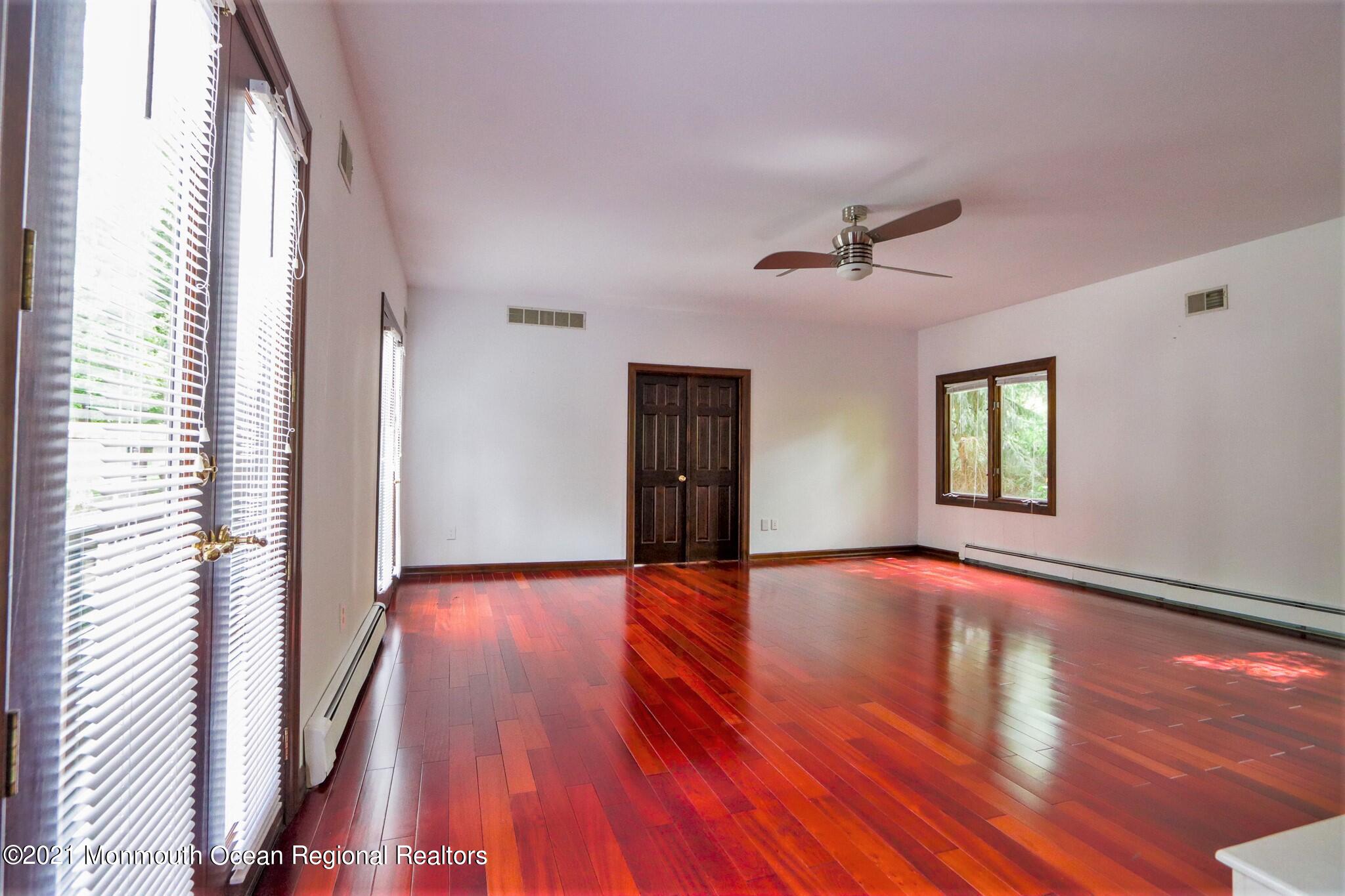 7 Perrine Circle Millstone Township, NJ 08535 - Photo 10 of 27 a view of an empty room with wooden floor and a window