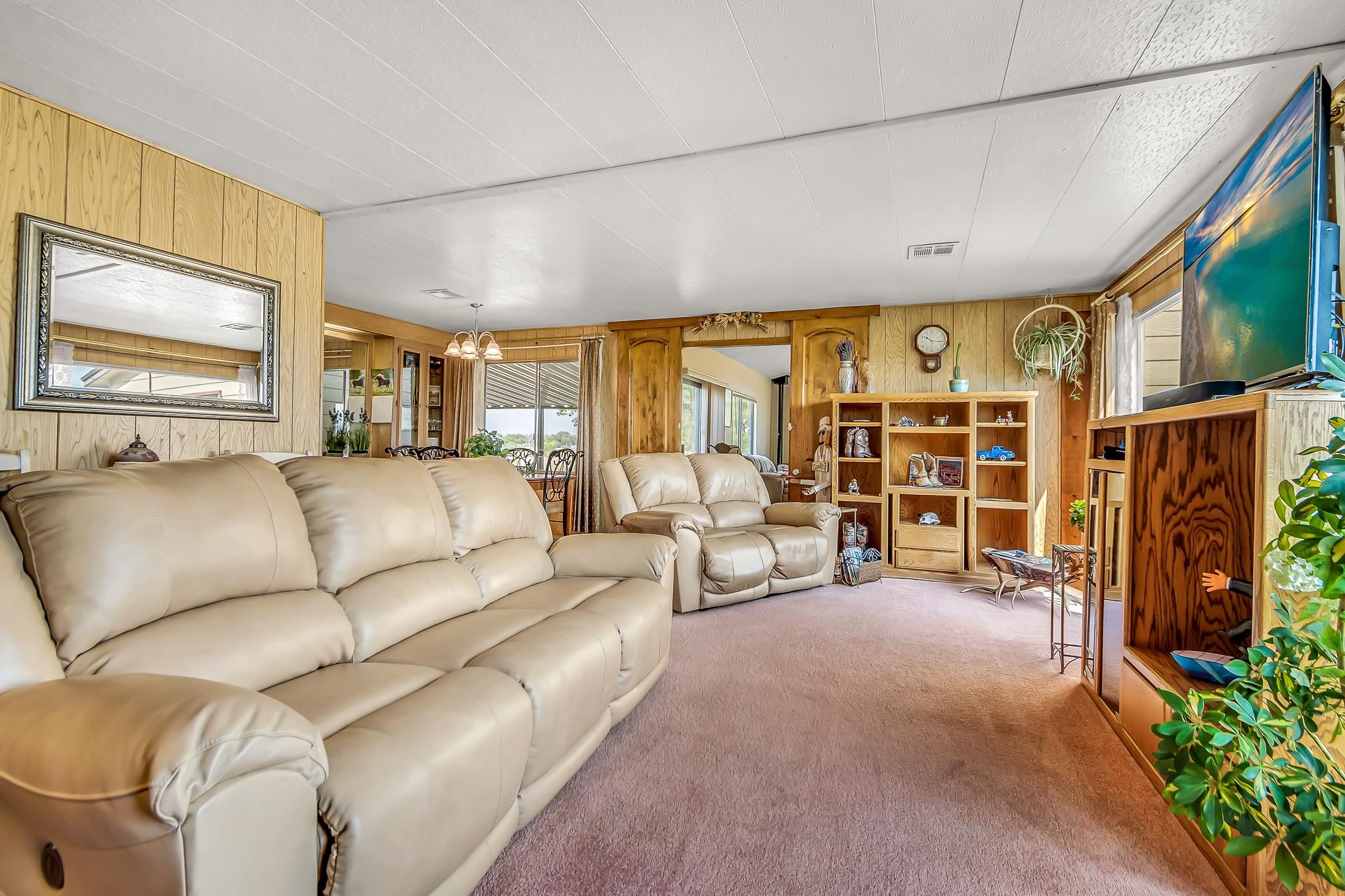 911 24 Road Grand Junction, CO 81505 - Photo 3 of 29 a living room with furniture and a flat screen tv
