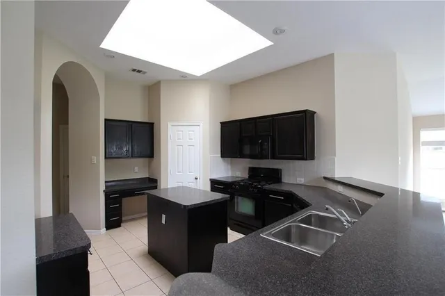 a view of a livingroom with a fireplace and window