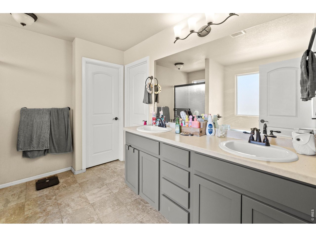8847 16th St Road Greeley, CO 80634 - Photo 22 of 38 a bathroom with a sink vanity and mirror