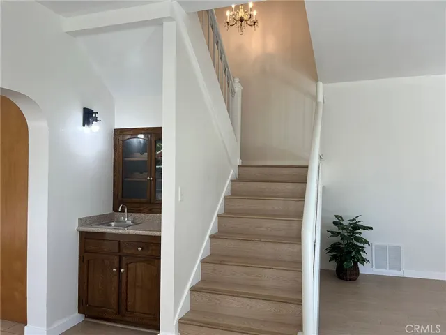 a view of a hallway with wooden floor and entryway