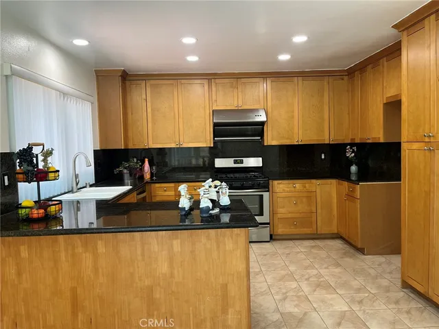 a kitchen with stainless steel appliances a stove a sink and a refrigerator