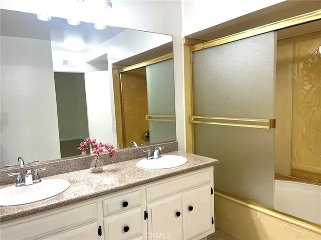 a bathroom with a granite countertop sink mirror and double