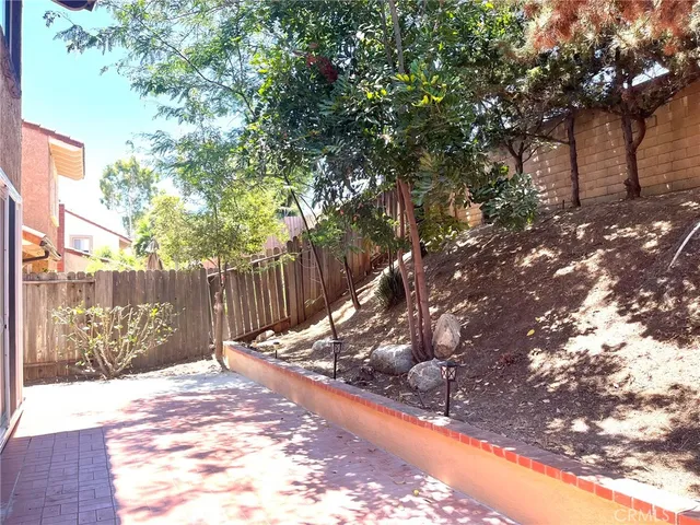 a view of a backyard with a tree