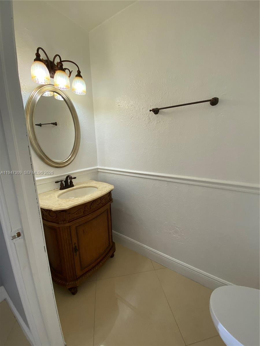 3503 West 76th Street, Unit 4 Hialeah, FL 33018 - Photo 14 of 31 a bathroom with a sink a toilet and mirror