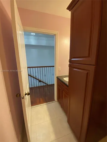 an empty room with wooden floor and entrance