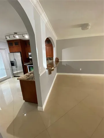 a kitchen with stainless steel appliances granite countertop a refrigerator and a sink