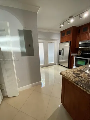 a kitchen with stainless steel appliances granite countertop a stove a sink and a microwave