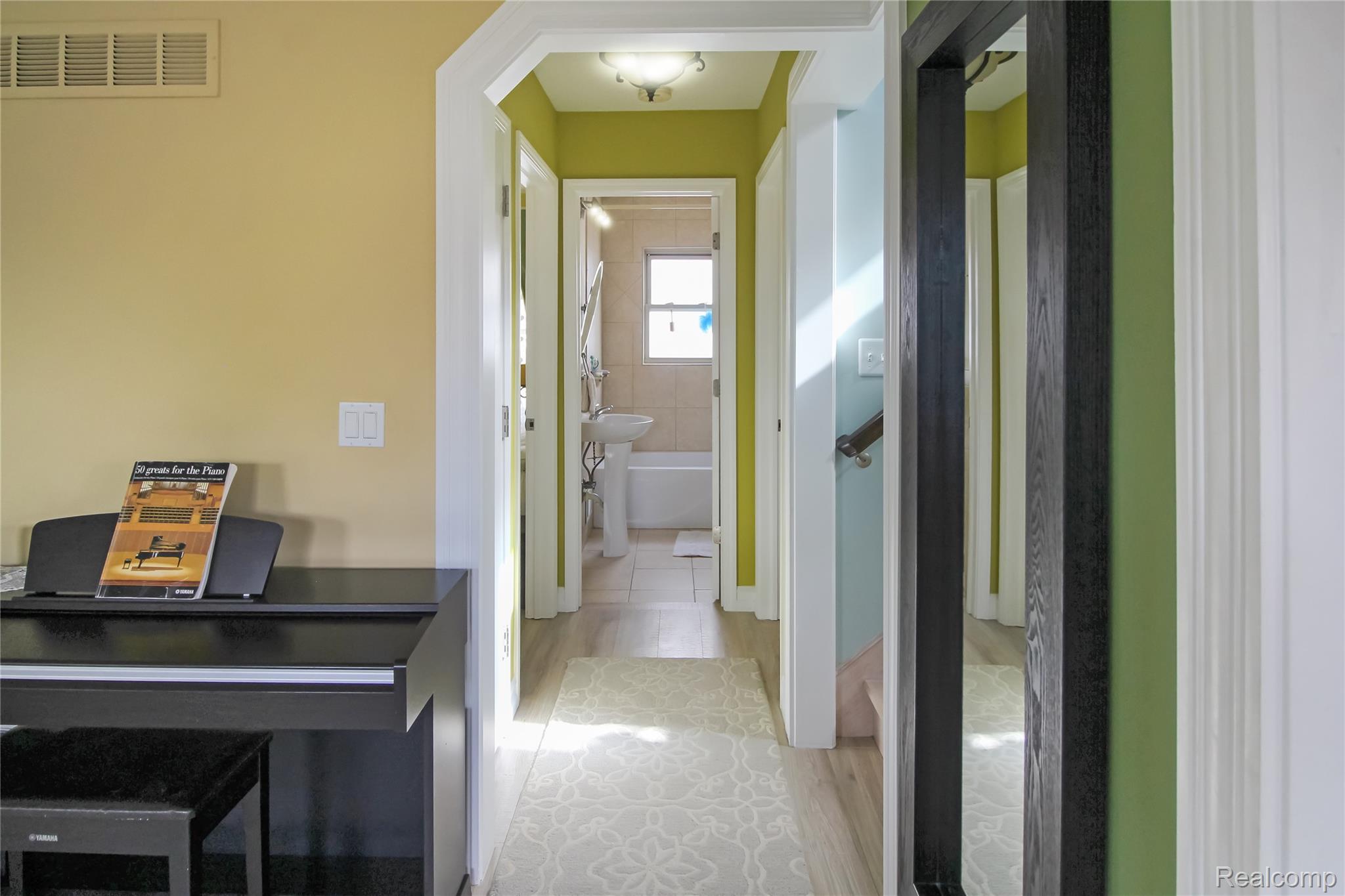 5953 Cooper Street Taylor, MI 48180 - Photo 5 of 33 Hallway featuring wood-finish flooring, white trim, and a built-in overhead light fixture
