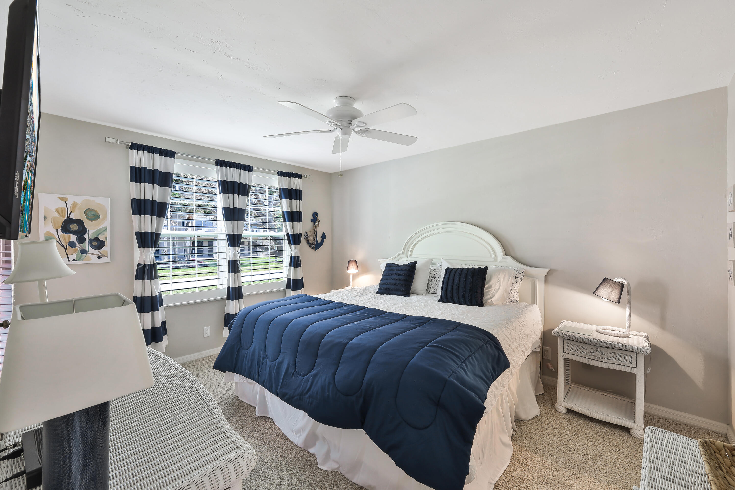 960 Huron Street, Unit 106 Marco Island, FL 34145 - Photo 14 of 39 a bedroom with a bed and a chandelier