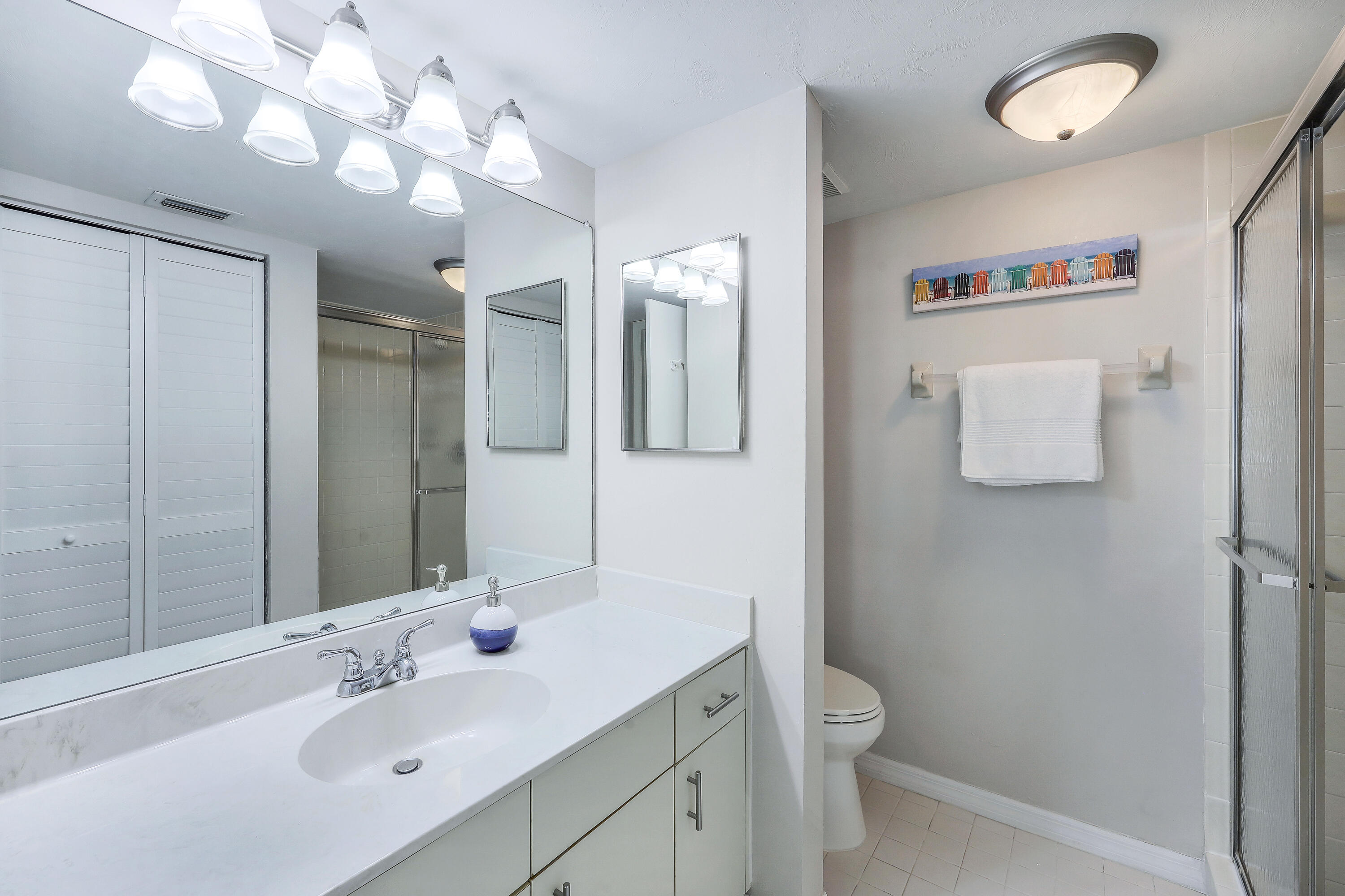 960 Huron Street, Unit 106 Marco Island, FL 34145 - Photo 15 of 39 a bathroom with a toilet sink and mirror