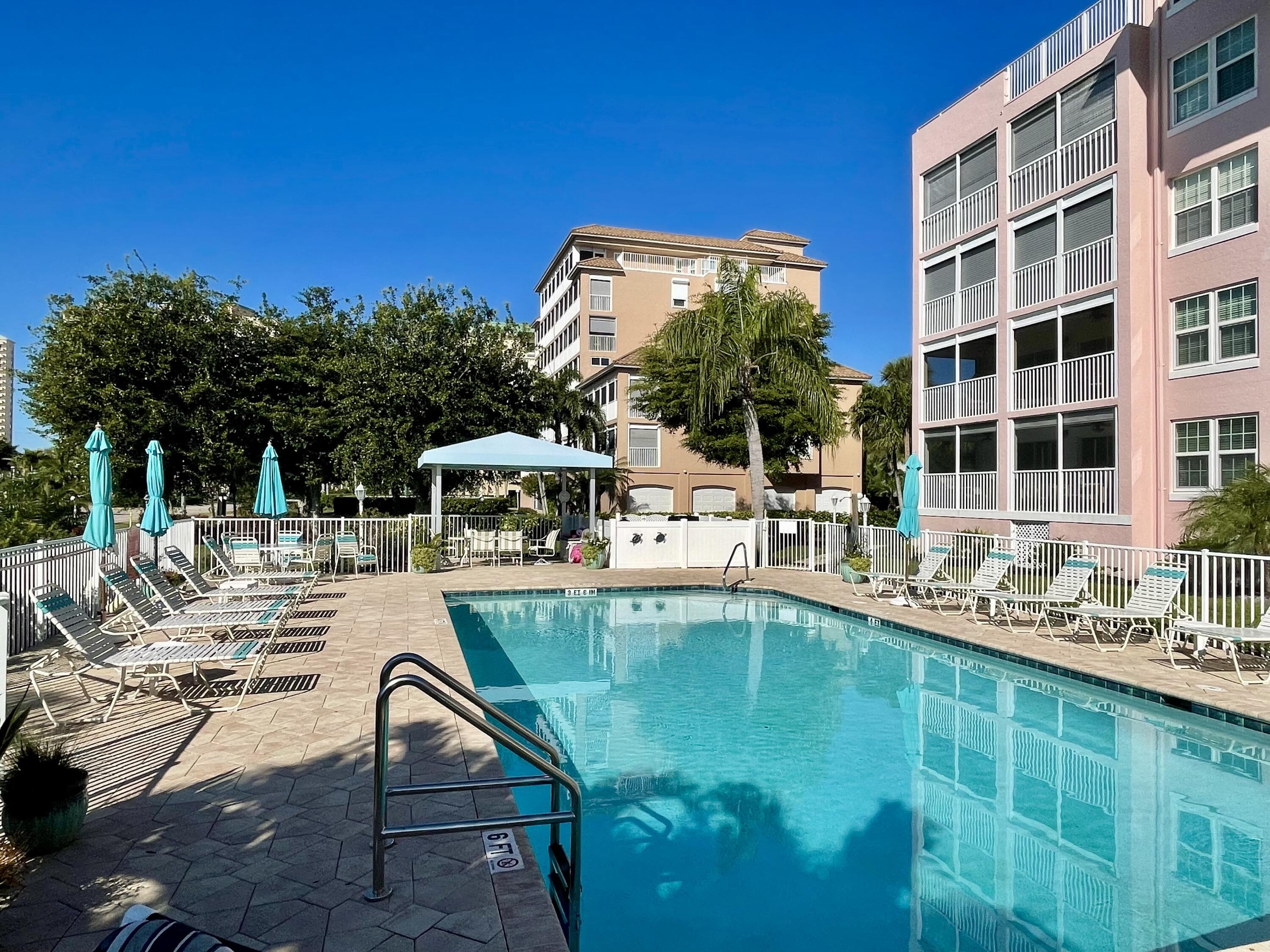 960 Huron Street, Unit 106 Marco Island, FL 34145 - Photo 27 of 39 a view of a swimming pool with a patio